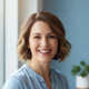 Smiling woman in her late 30s with a warm and trustworthy expression.