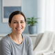 Candid portrait of a smiling woman in her late 30s, representing a happy and satisfied customer.